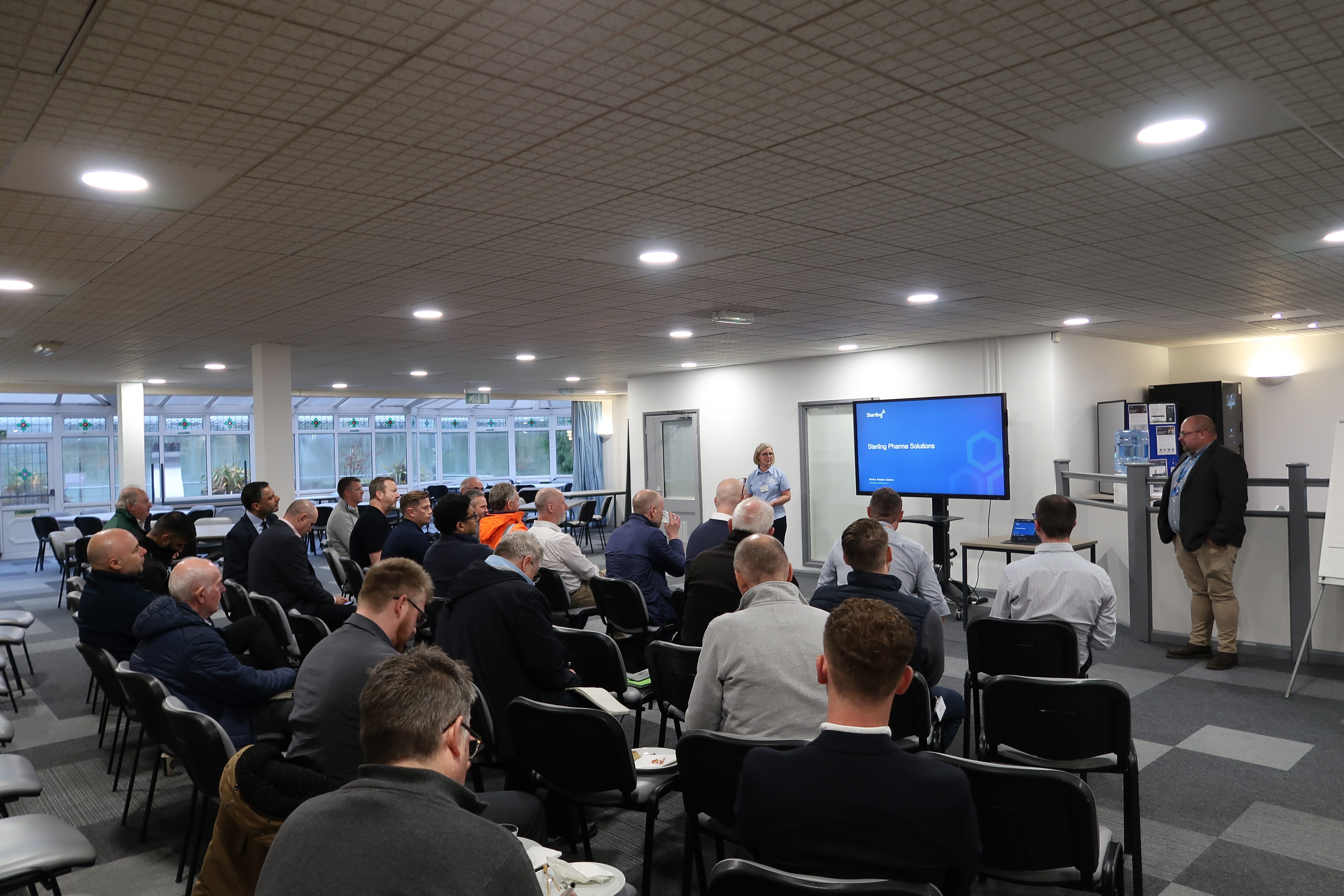 Attendees of the ISPE visit at Radiofilum Pharmaceutical Solutions' facility sitting for a presentation
